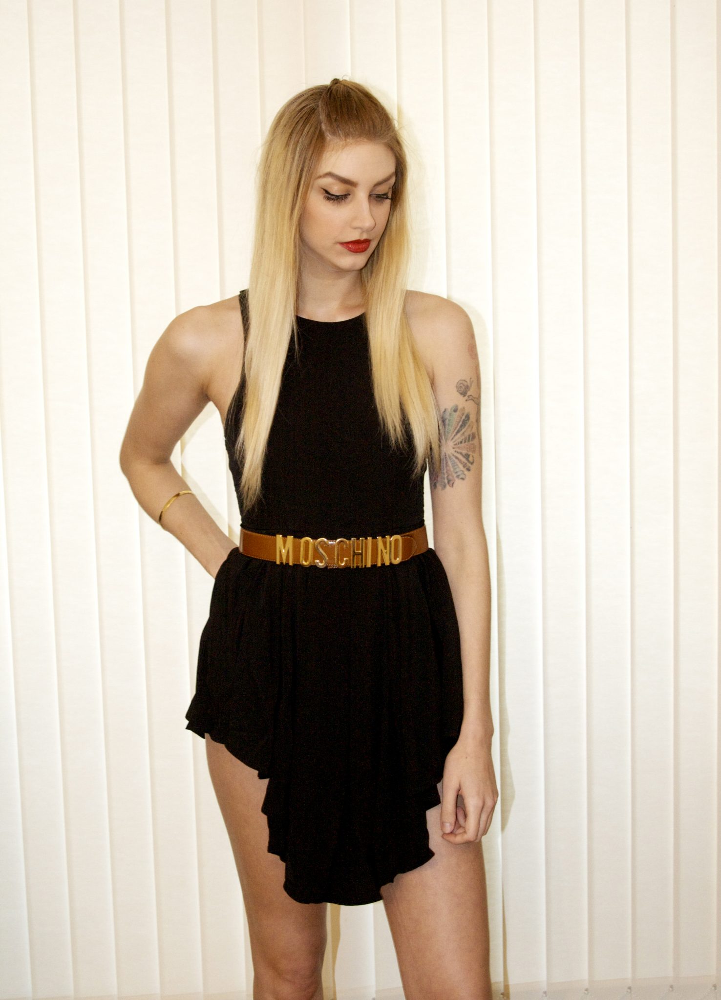 Manchester based fashion and lifestyle blogger. Whitefox boutique black waterfall playsuit, Moschino belt, New look shoes, toni and guy blonde, tattoos.